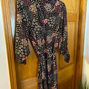 Floral black dress with zipper neckline and tie waist. 3/4 button sleeves